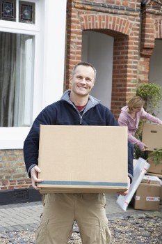 Worker loading boxes safely into a van