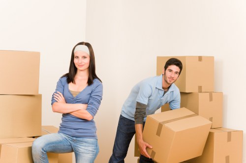 Packers handling boxes during a local home move in Hampstead