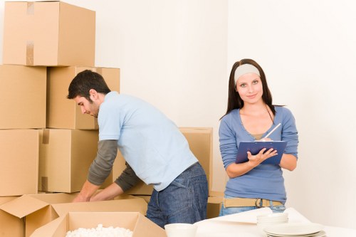 Driver and helper managing furniture delivery and unloading